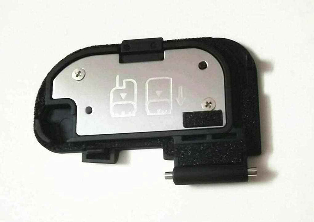 Camera battery door cover repair part, black plastic with metal insert and hinges