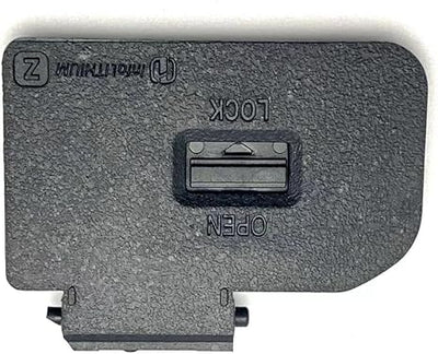 Dark gray battery door cover with latch slot and mounting tabs for camera repair